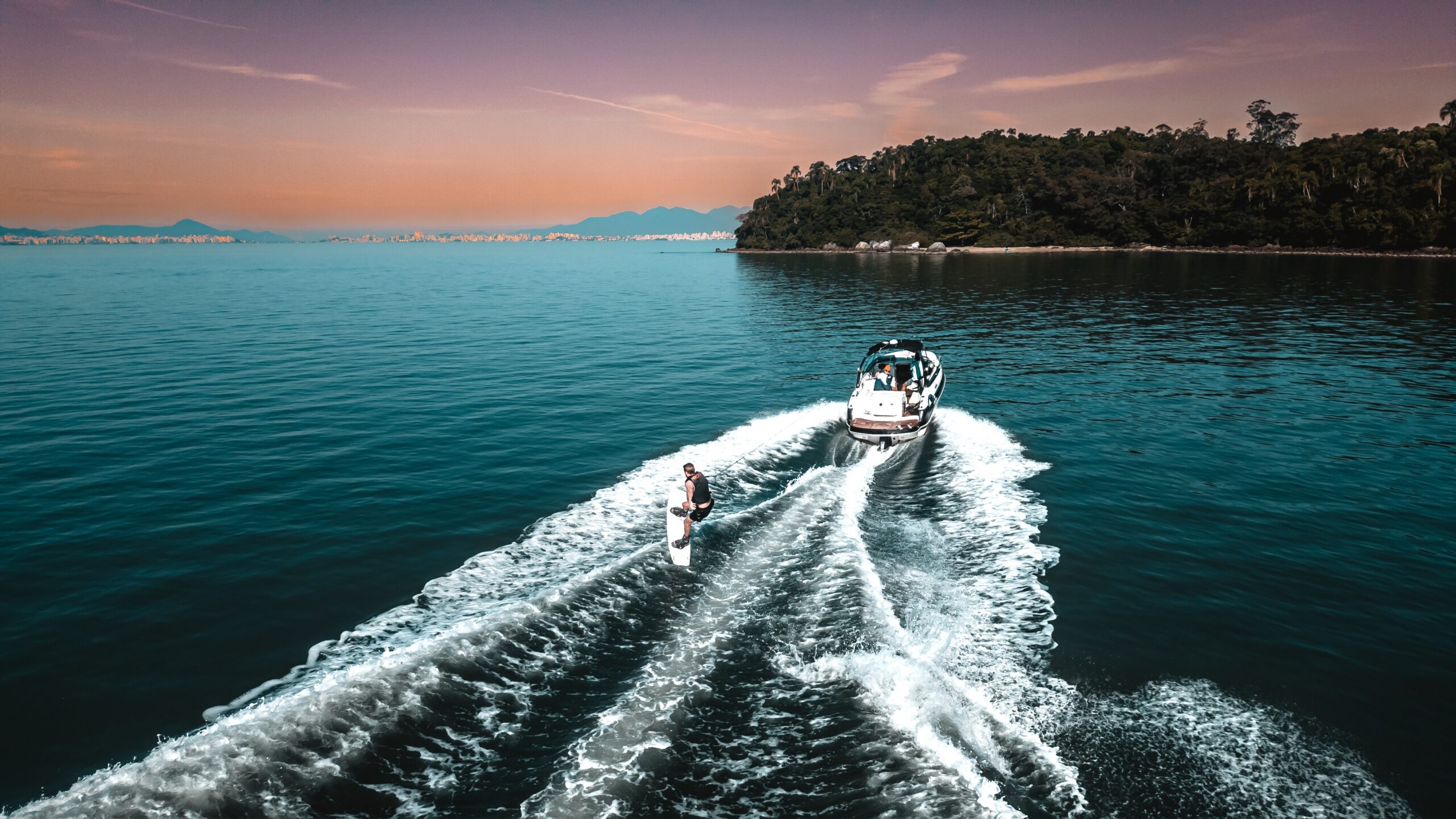 Speedboat pulling wakeboarder