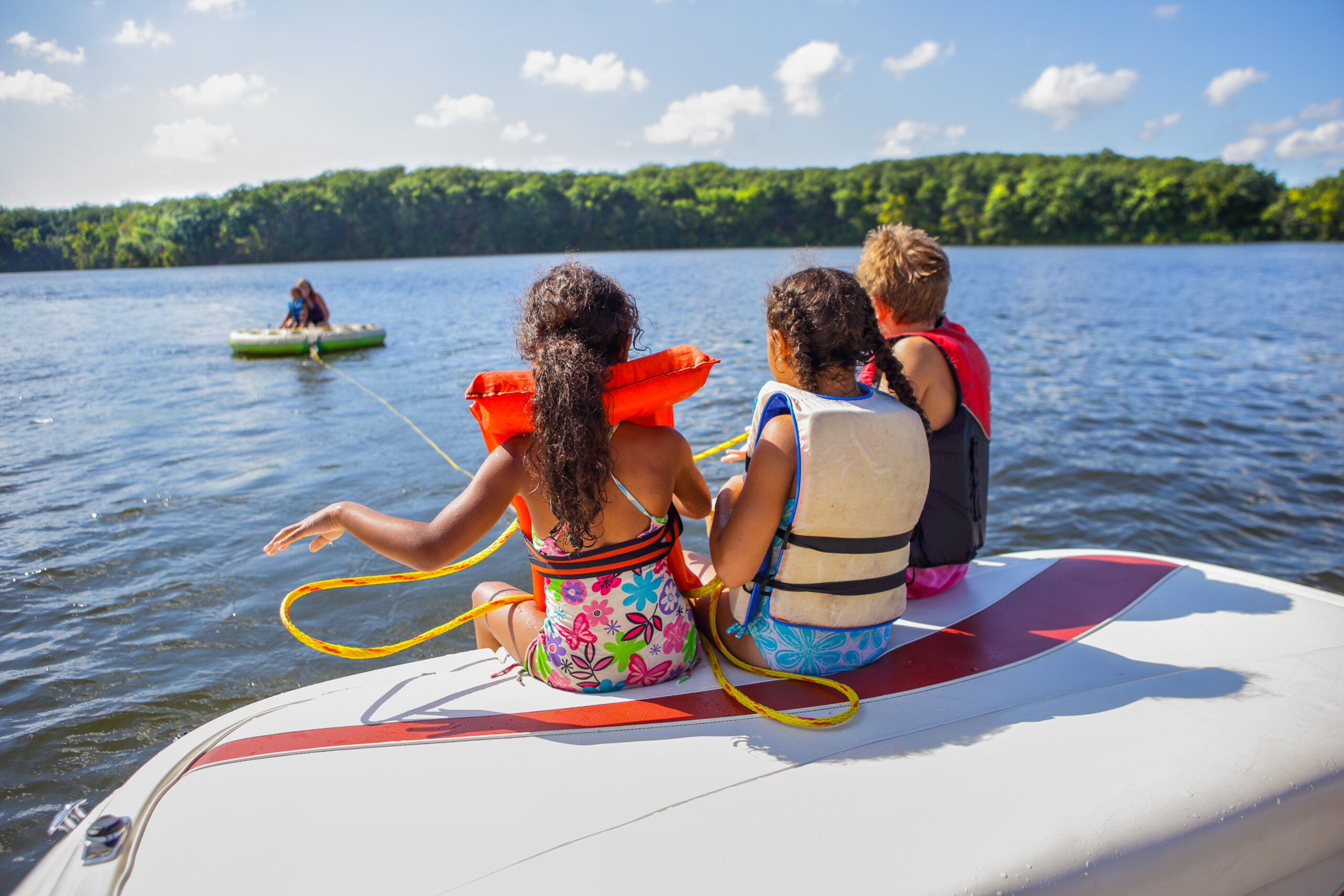 family tubing from a boat