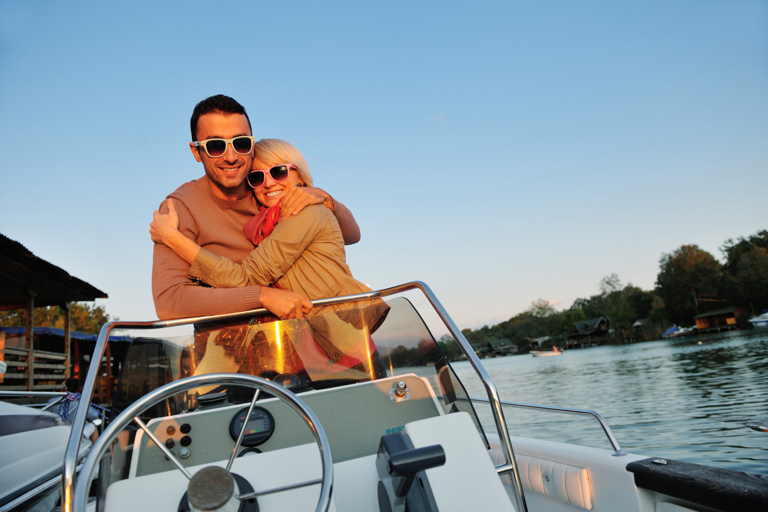 happy young couple enjoying a boat ride