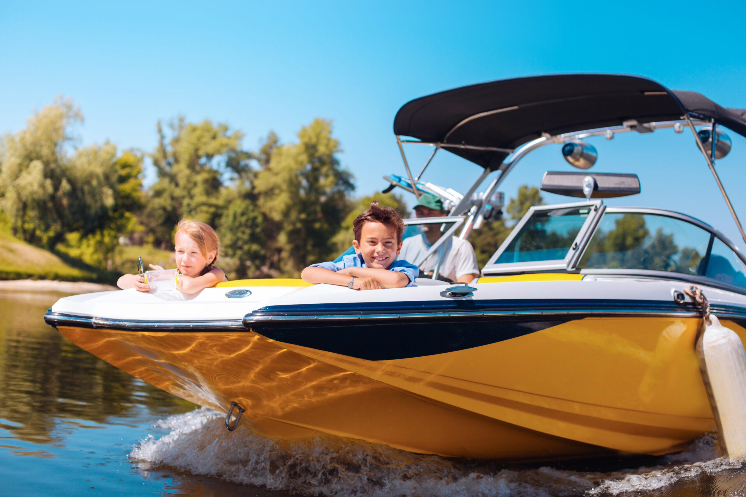 kids on boat listening to music with dad