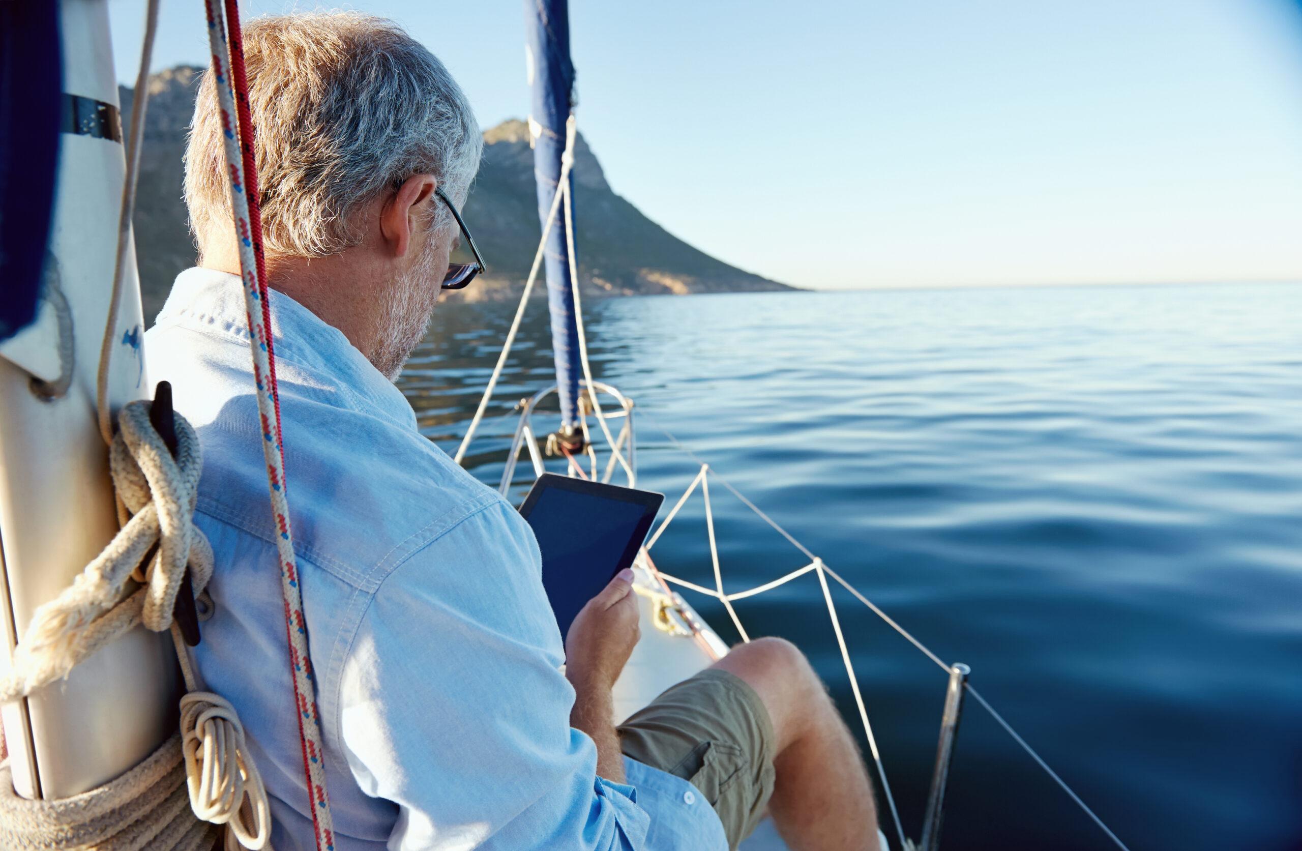 man on boat reading ebook
