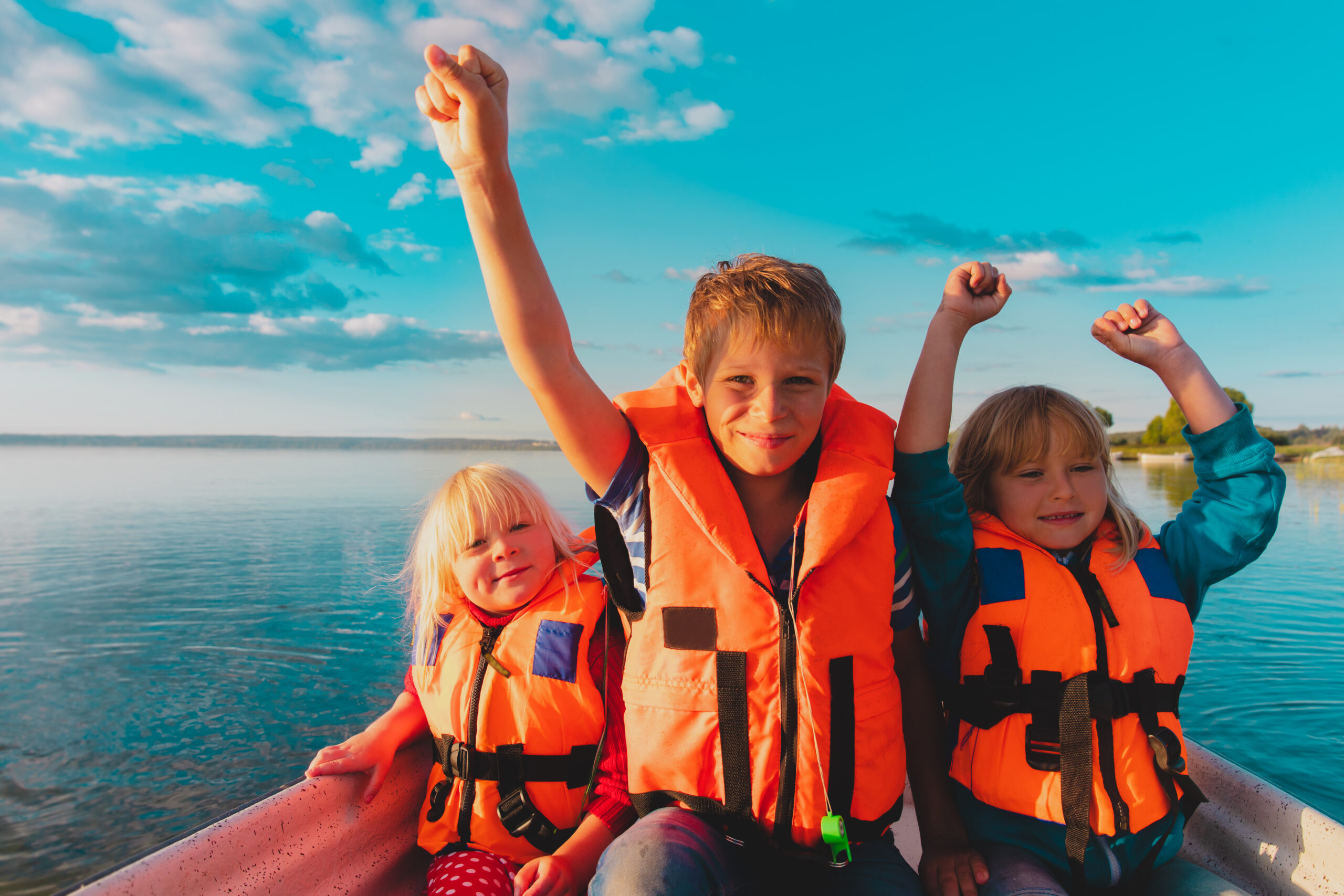 kids on boat in life jackets