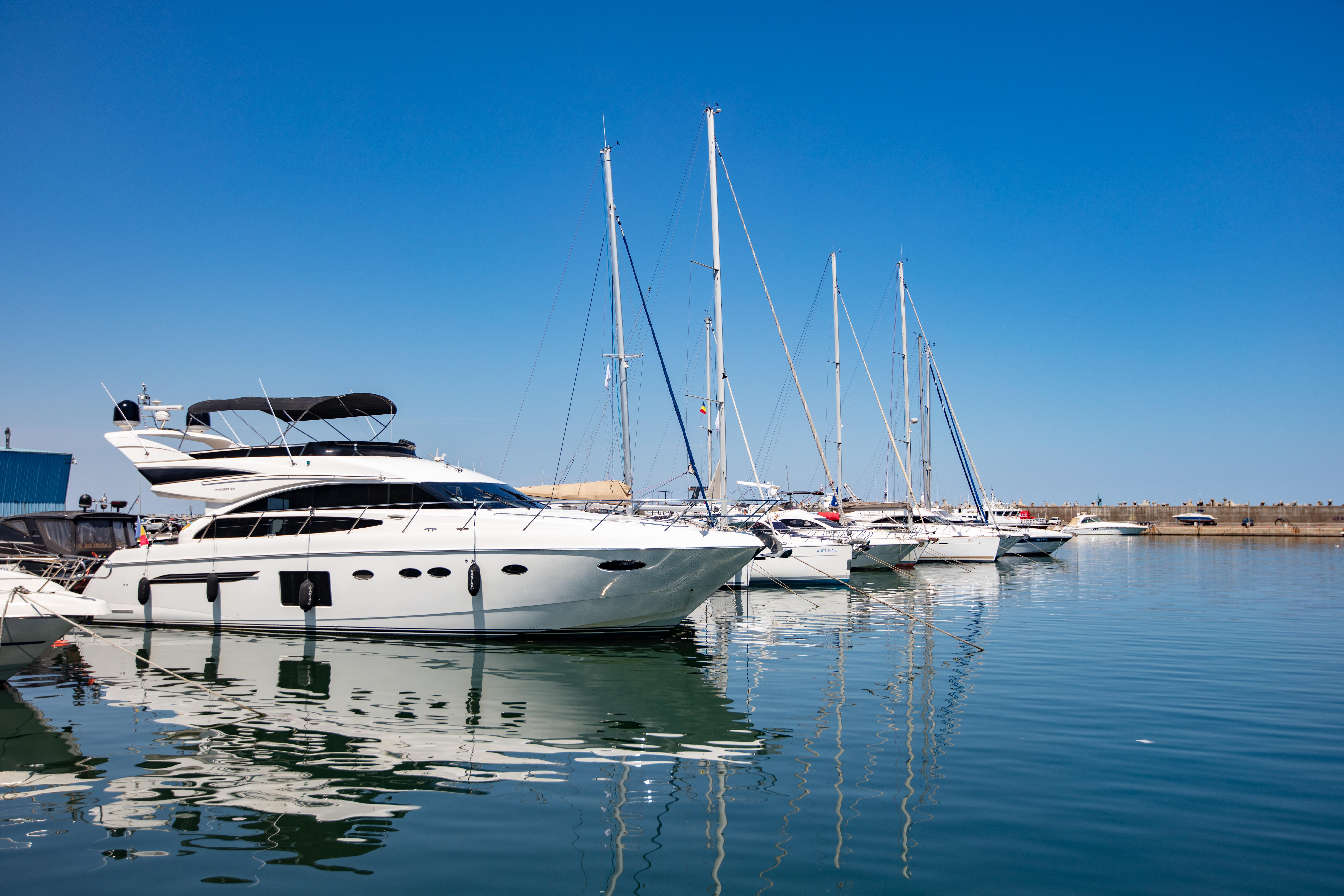 motor yachts and sailboats at a dock